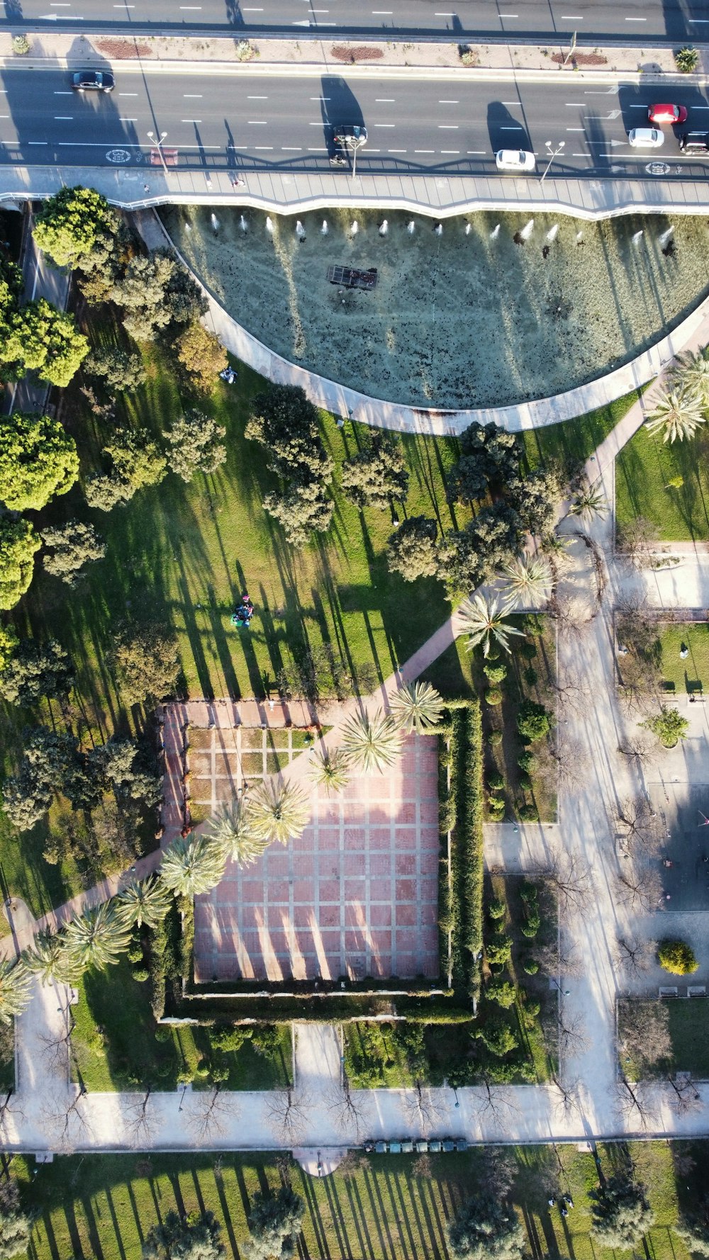 an aerial view of a park and a road
