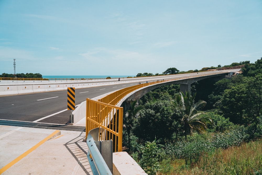 a view of a highway with a yellow railing