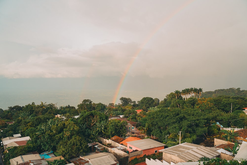 a rainbow in the sky over a small town