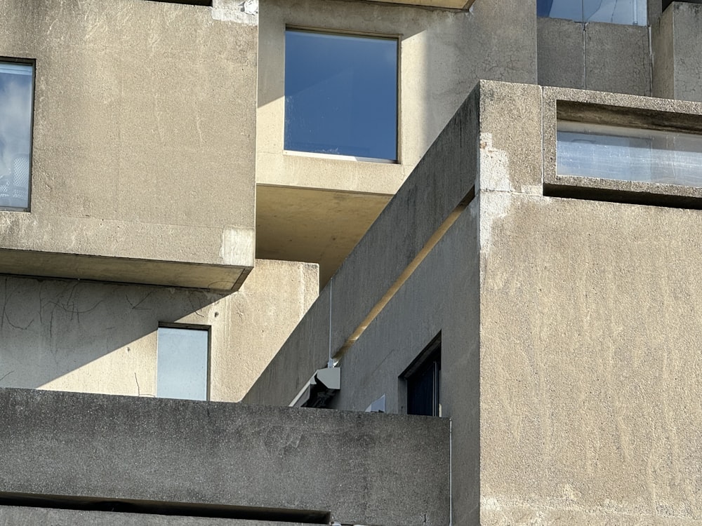 a tall building with windows and a sky in the background