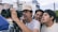 a group of young men standing around a camera