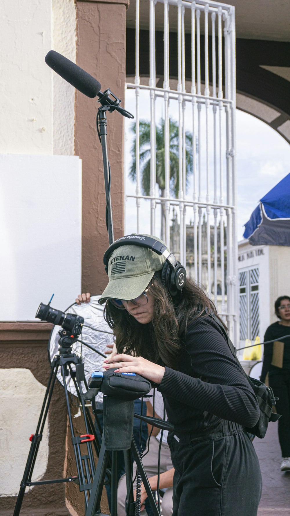 a woman with headphones and a camera on a tripod