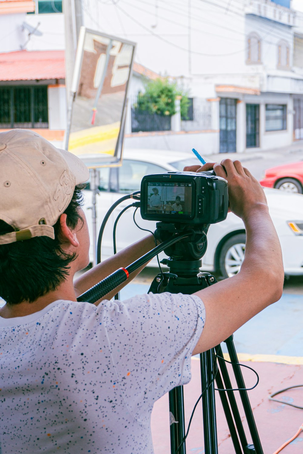 a man holding a camera on a tripod