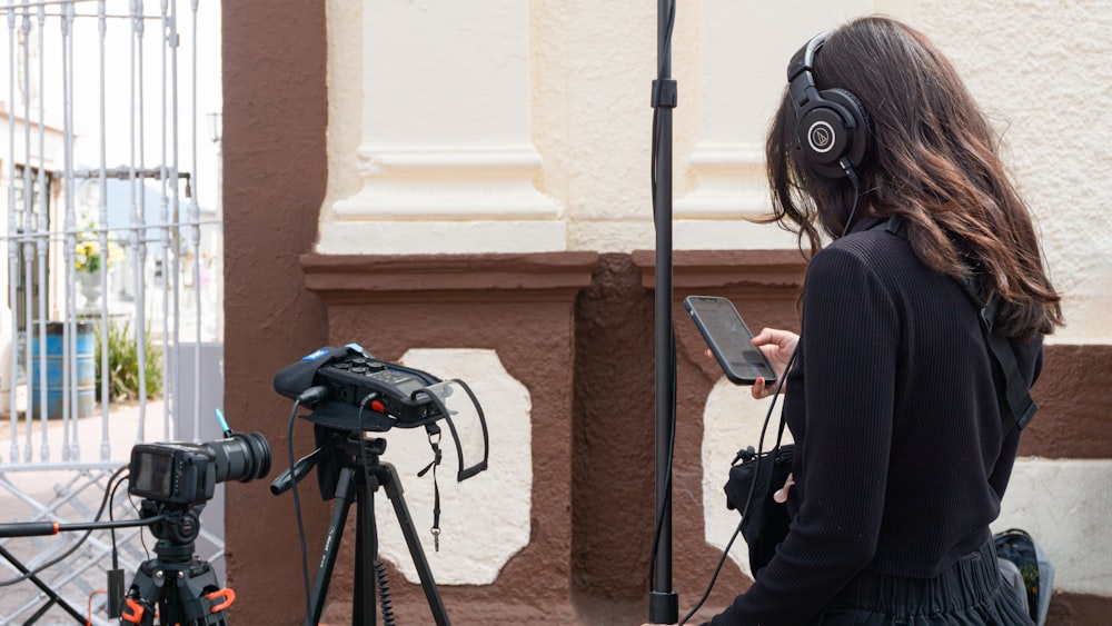 a woman with headphones and a cell phone