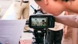 a person holding a camera with a video on it