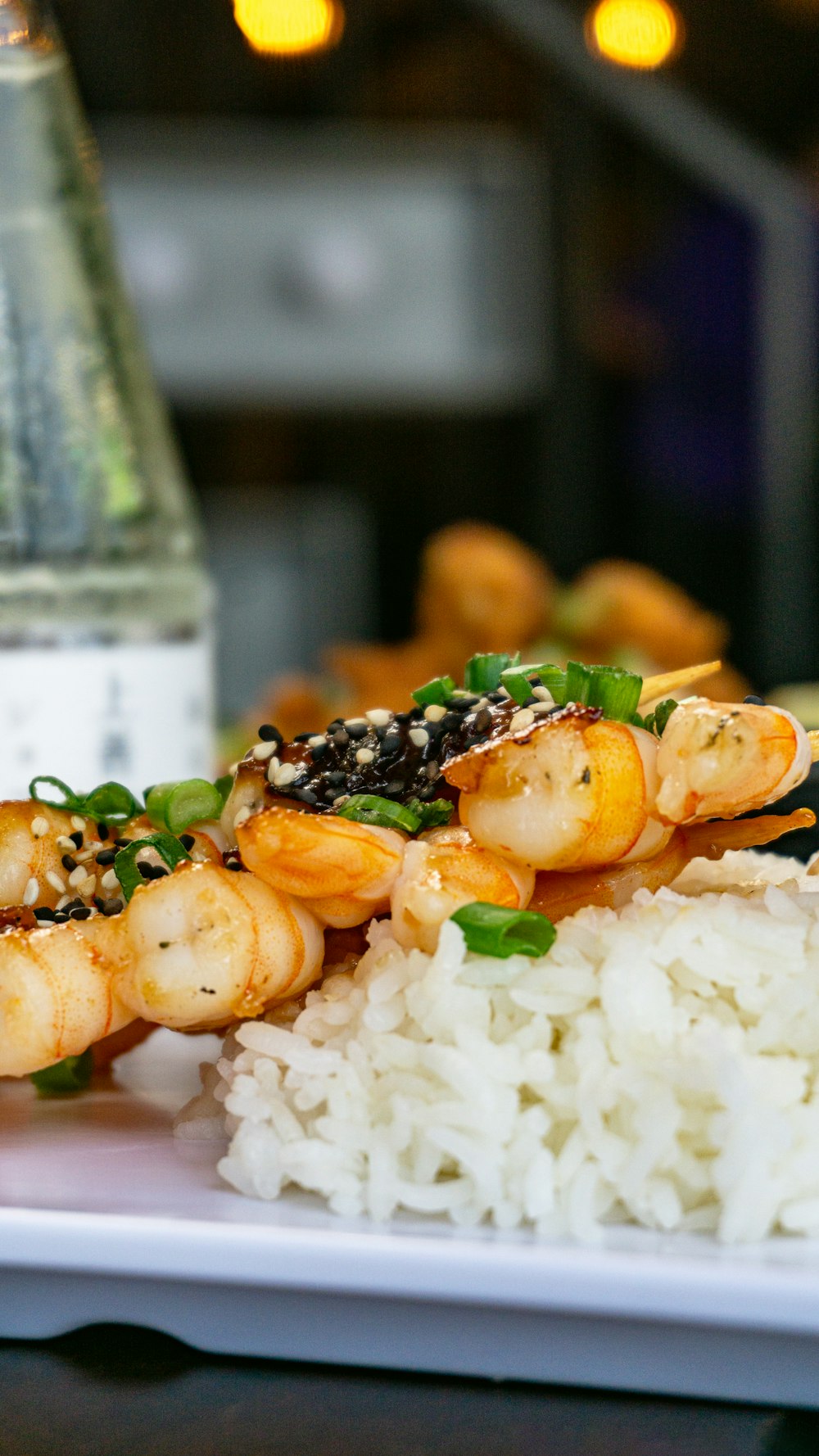 a white plate topped with rice and shrimp