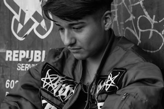 A clean photo of a model wearing a minimalistic jacket with abstract line patterns evoking deep thought.