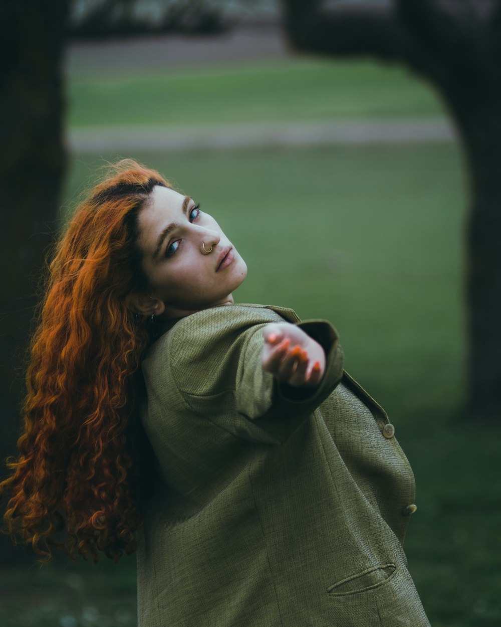 a woman with red hair is pointing at something