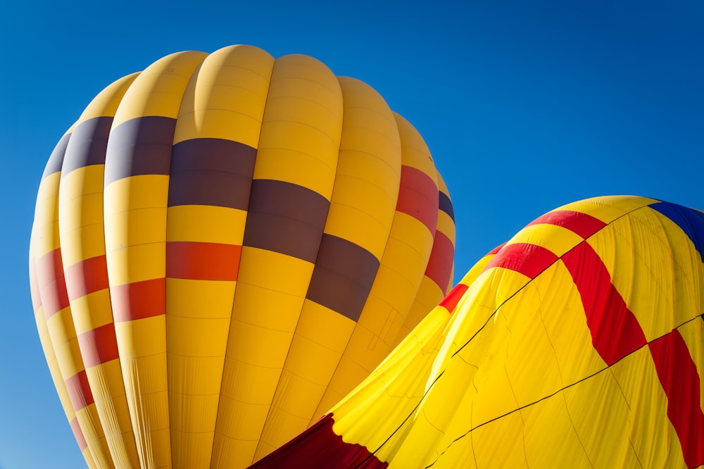 a couple of hot air balloons flying in the sky