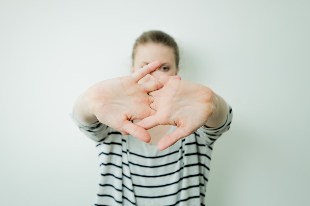 a woman making a heart with her hands