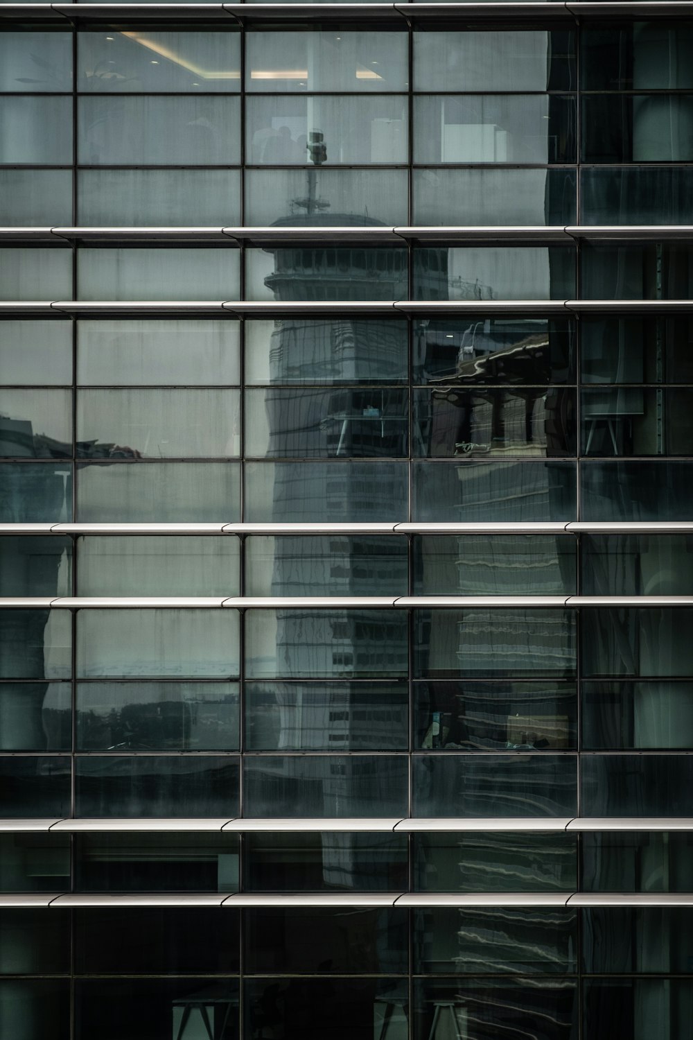 the reflection of a building in the windows of another building