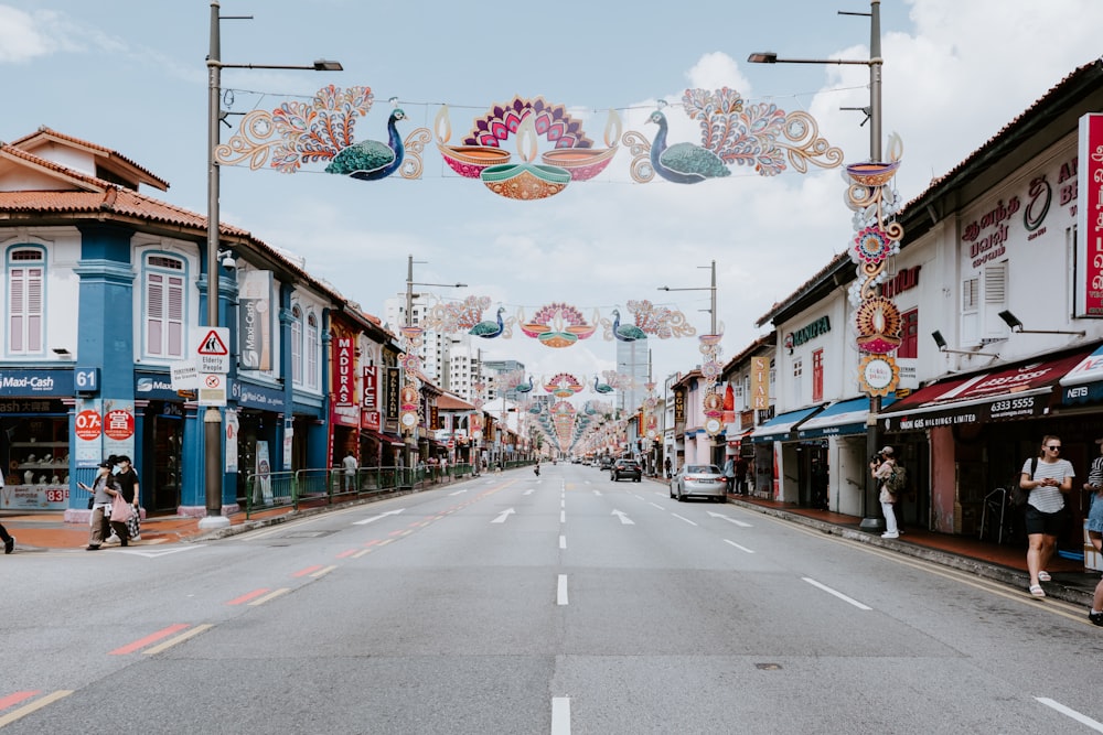 a street lined with shops and people walking down it