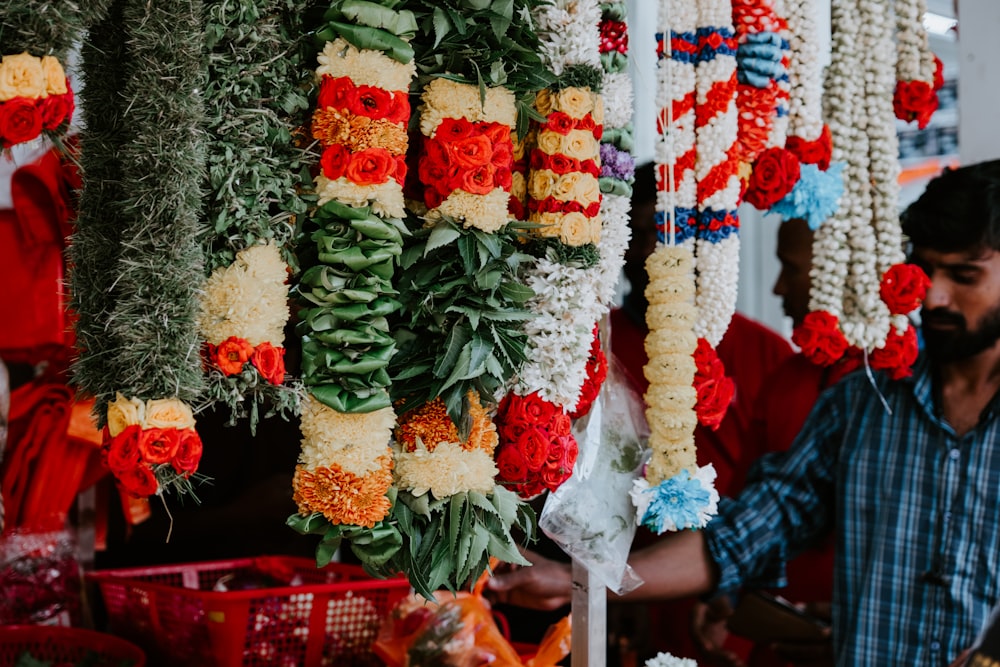 a man standing in front of a display of flowers