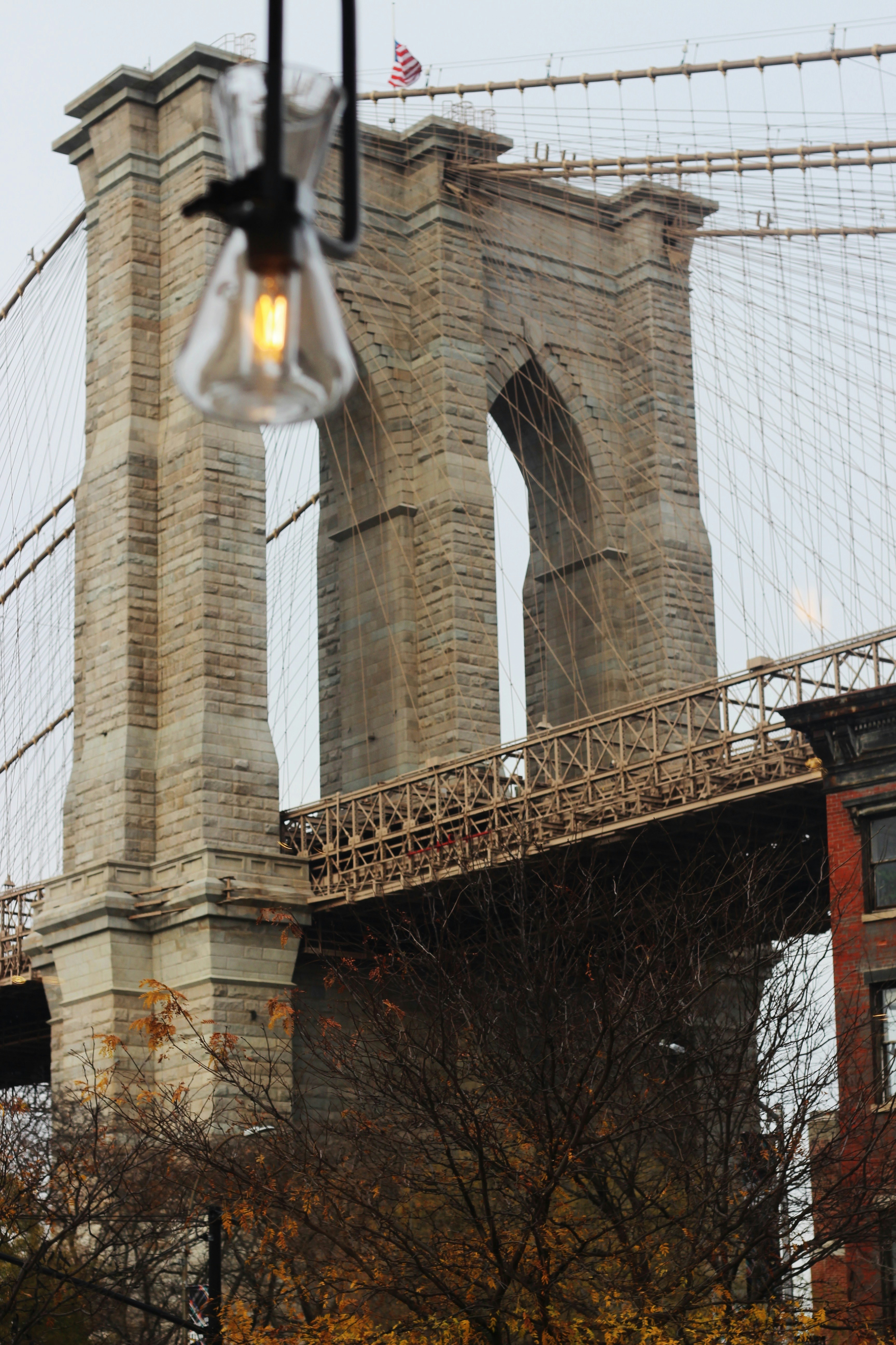 a street light hanging from the side of a bridge