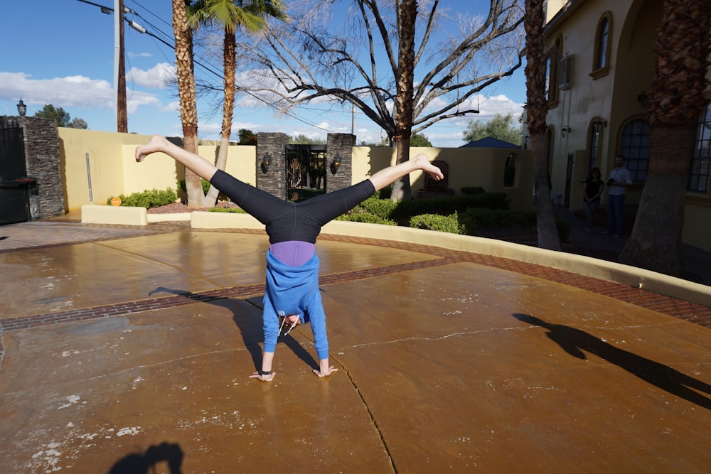 a person doing a handstand on a skateboard