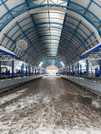 an empty train station with a lot of snow on the ground