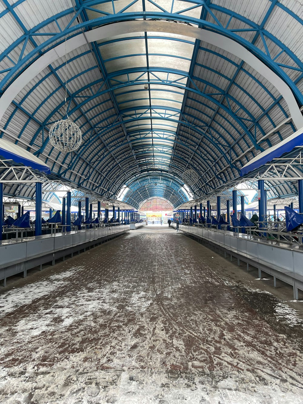 an empty train station with a lot of snow on the ground