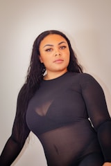 A striking black-and-white photo of a model wearing edgy noir wolf fashion pieces, standing confidently in an urban night setting.