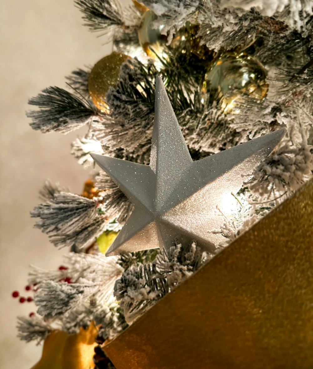 a silver star on top of a christmas tree