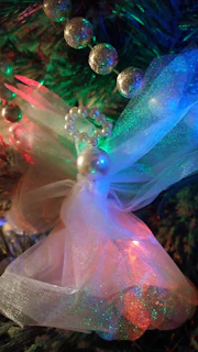 Handmade mobile charms with tiny sparkly stars and pastel beads hanging from a delicate chain.