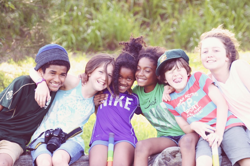 a group of young people sitting next to each other