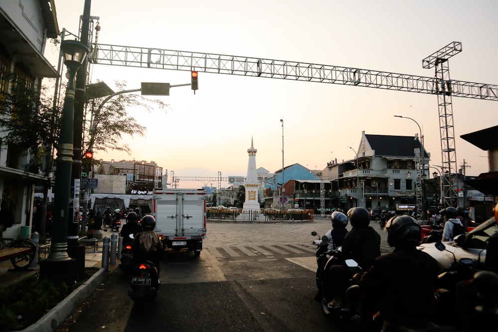 a group of people riding motorcycles down a street