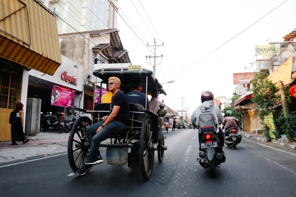 a group of people riding on the back of a horse drawn carriage