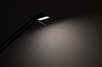 Minimalist lamp casting a warm glow over a clean, airy space with soft textures.