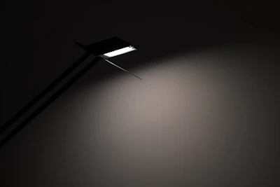 Minimalist desk lamp crafted from translucent glass blocks casting soft light