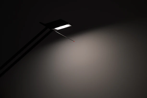 Close-up of a sleek, minimalist LED lamp casting a gentle glow on a stylish interior.