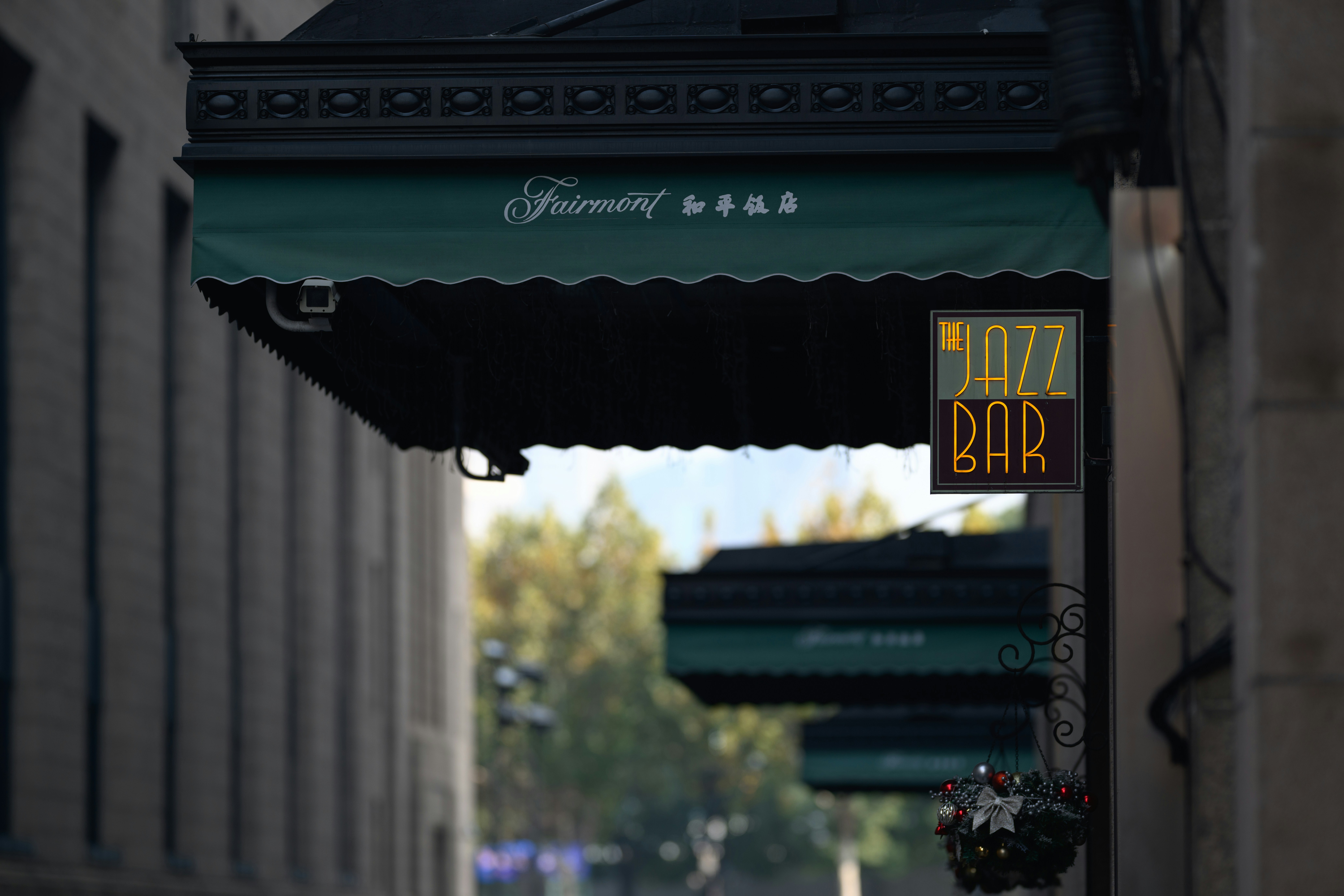 a restaurant sign hanging from the side of a building