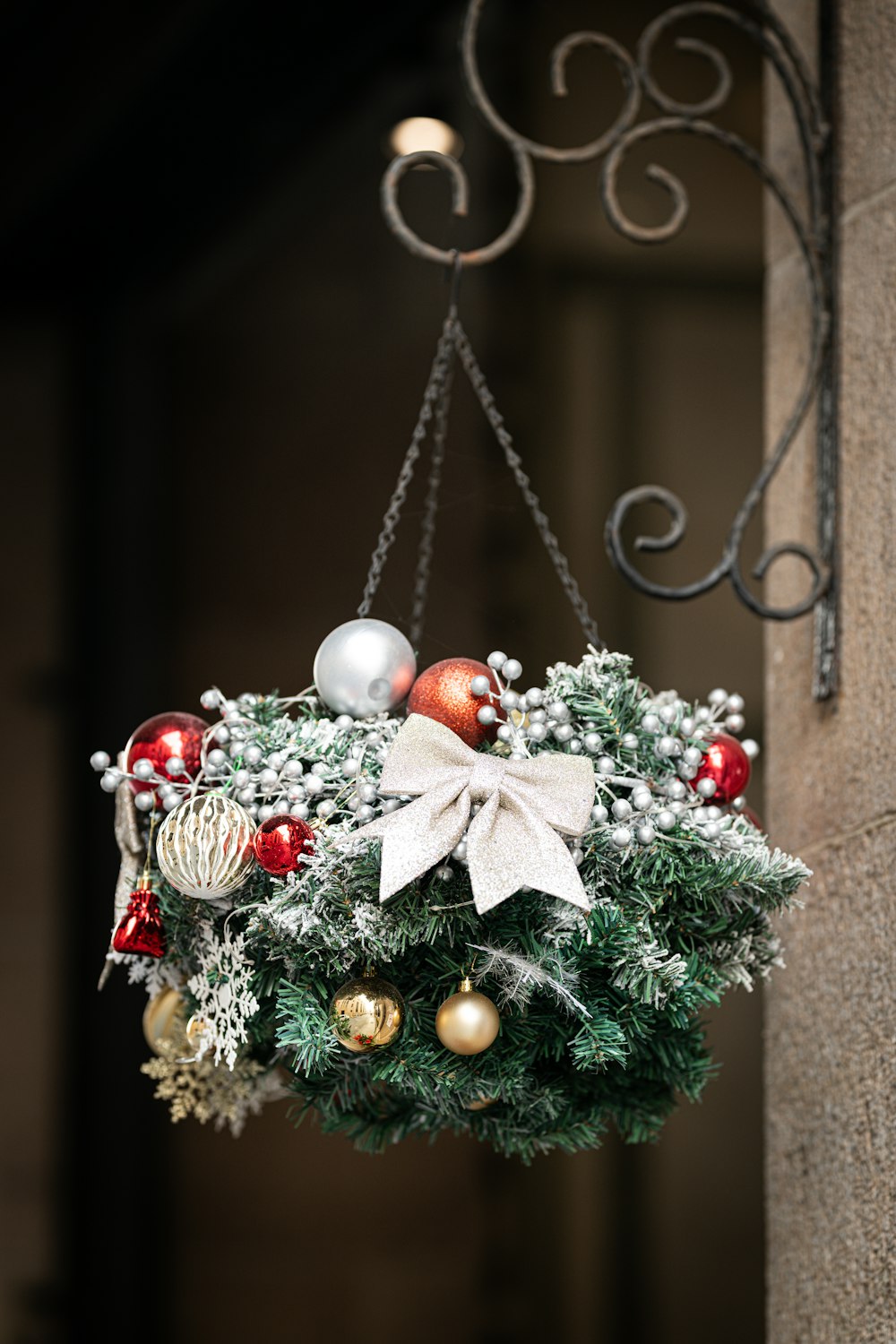 a christmas wreath hanging from the side of a building