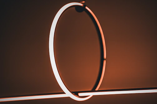 Elegant lighting fixture casting warm shadows over a minimalist space.