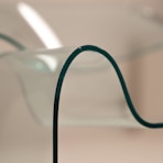 a close up of a glass vase with a metal stand