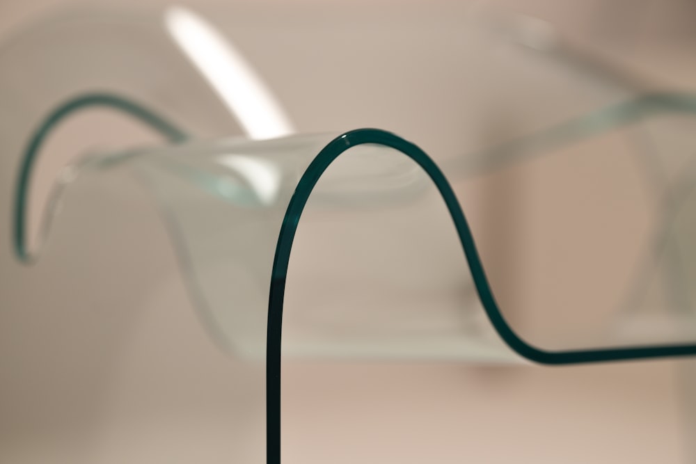 a close up of a glass vase with a metal stand