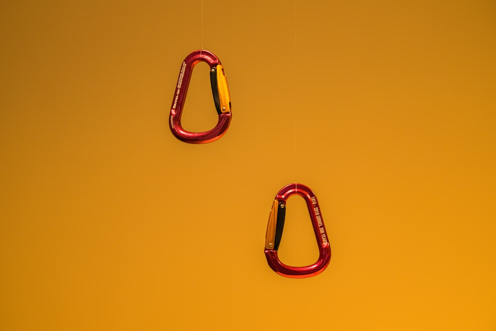 a pair of red carabines on a yellow background