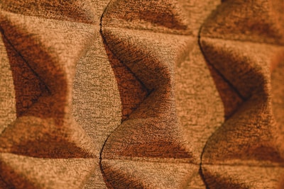 A detailed geometric pattern print with warm, light brown shades