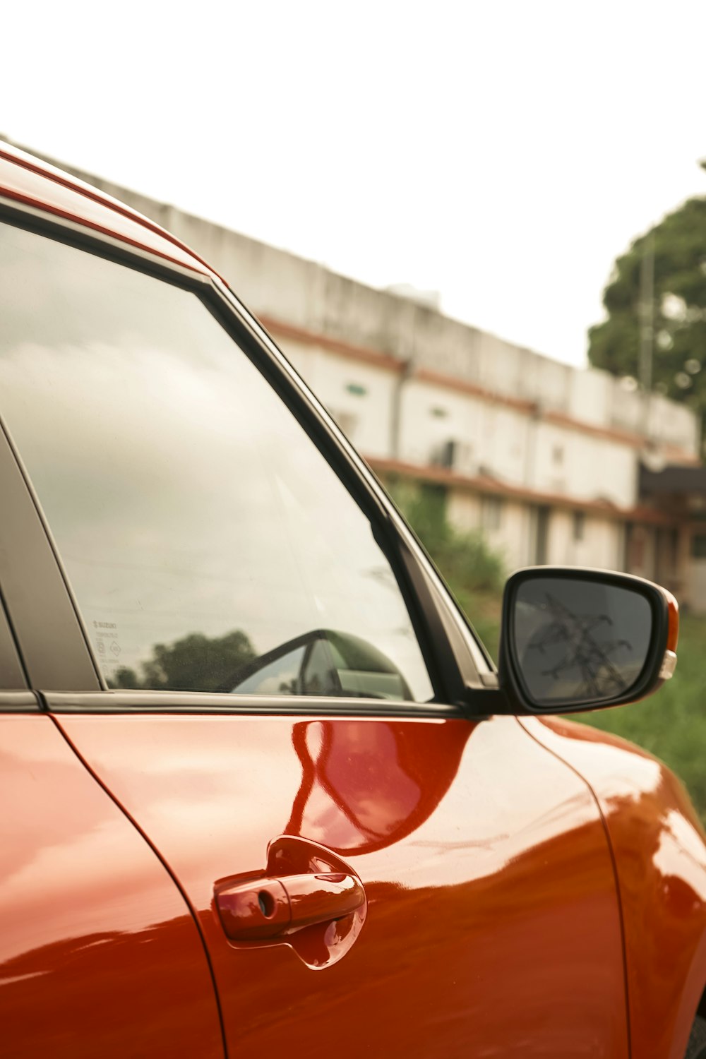 a red car parked in front of a building