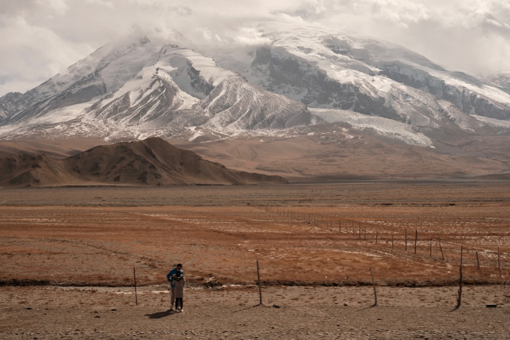 a person standing in front of a mountain