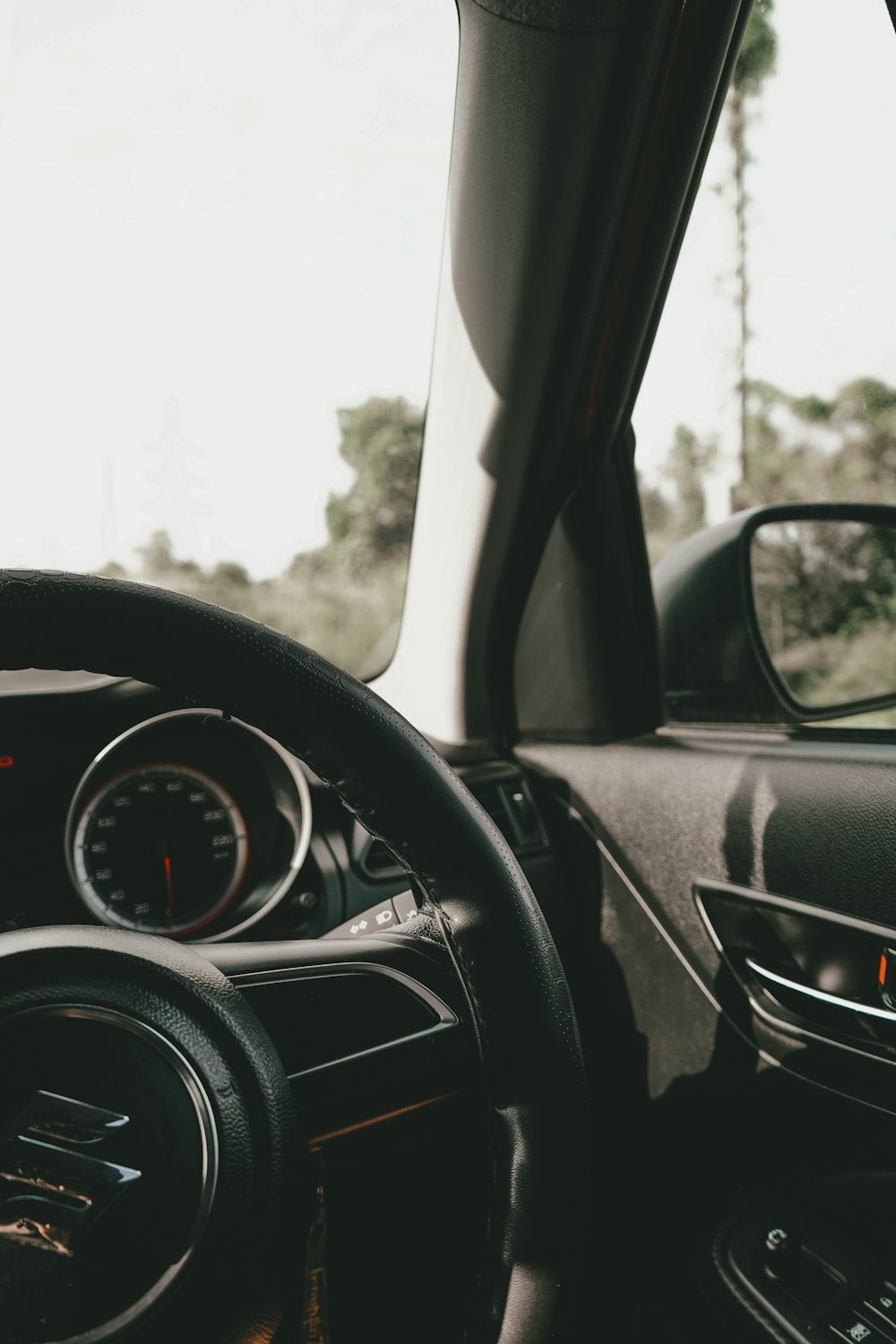 a car dashboard with a steering wheel and a dash board