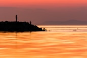 A panoramic view of Somalia’s coastline with fishermen at work during sunset.