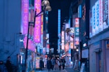 Colorful neon signs lighting up a crowded backstreet in Tokyo at night