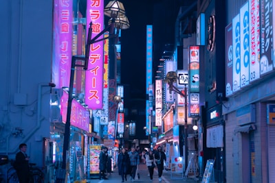 A vibrant street scene in Tokyo with colorful signs and bustling crowds