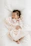 A cozy baby blanket with a soft pastel pink embroidery of a baby's name.