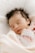 A peaceful sleeping baby wrapped in a soft blanket, with a calming atmosphere in the background.