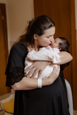 a woman holding a baby in her arms