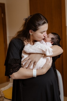 a woman holding a baby in her arms