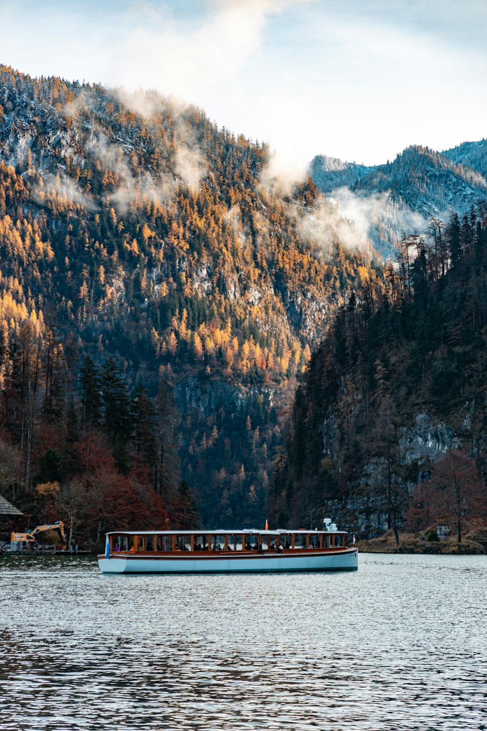 a boat on a lake with mountains in the background