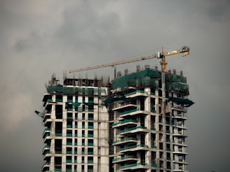 a tall building with a crane on top of it