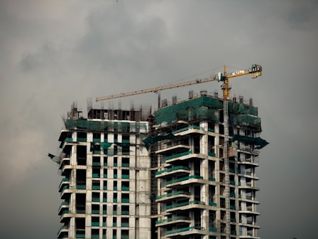 multiple tall building with a crane on top of it 